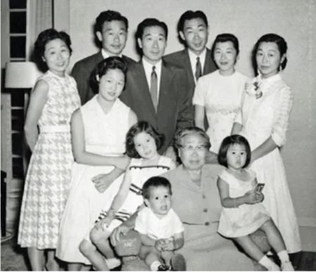 A black and white group photograph of ten members of the Ahn family, three generations, in a Los Angeles living room in 1956