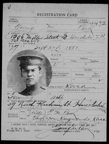 A registration card with a photograph of a young Korean man in uniform and handwritten entries, for Pak Young Man